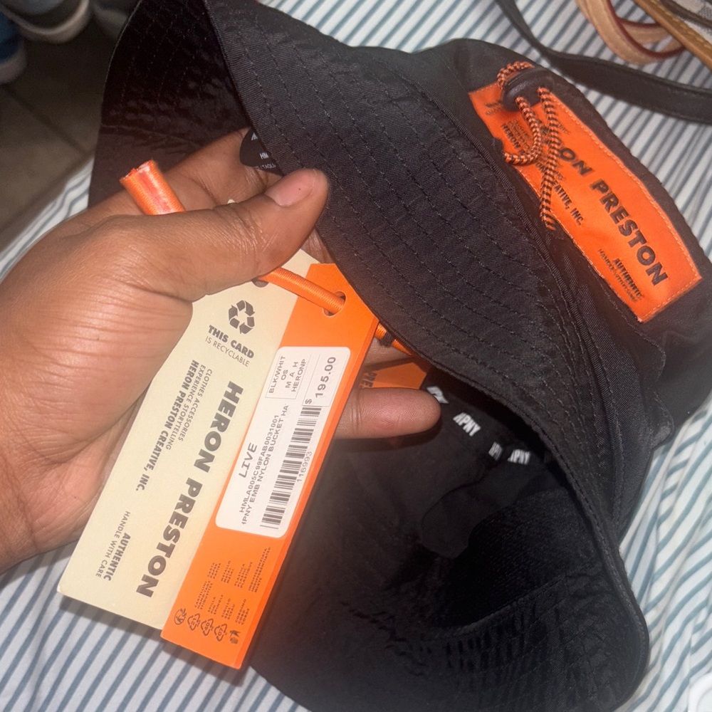 Heron Preston Black Hat with Vibrant Orange Details